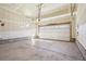 Empty attached garage with concrete floor and roll up door at 24437 E Powers Ave, Aurora, CO 80016