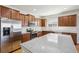 This kitchen features stainless steel appliances, a granite island, and sleek, modern cabinetry at 24437 E Powers Ave, Aurora, CO 80016