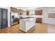 Modern kitchen features stainless appliances, an island with granite countertops, and sleek cabinetry at 24437 E Powers Ave, Aurora, CO 80016