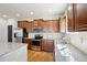 Kitchen featuring stainless appliances, granite counters, and rich wood cabinets is ready for cooking at 24437 E Powers Ave, Aurora, CO 80016