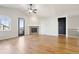 Hardwood living room with a fireplace, door to patio, and iron railing to the basement at 24437 E Powers Ave, Aurora, CO 80016