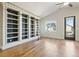 Light-filled living room boasting hardwood floors, built-in shelving, and a modern ceiling fan at 24437 E Powers Ave, Aurora, CO 80016