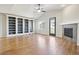 Open living room featuring hardwood floors, a fireplace, built-in bookshelves and vaulted ceiling at 24437 E Powers Ave, Aurora, CO 80016