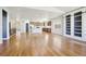Bright, open living room with hardwood floors and a built-in bookshelf offers a cozy atmosphere at 24437 E Powers Ave, Aurora, CO 80016