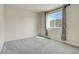 Bright bedroom featuring neutral walls, carpet, large window with curtain at 3310 Quicksilver Rd, Frederick, CO 80516
