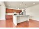 Bright and open kitchen features a large island with pendant lights and modern stainless steel appliances at 3310 Quicksilver Rd, Frederick, CO 80516