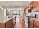 Modern kitchen showcasing granite countertops, stainless steel appliances, and a seamless flow into the dining area at 3310 Quicksilver Rd, Frederick, CO 80516