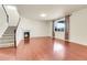 Inviting living room with hardwood floors, a cozy fireplace, and a staircase leading to the upper level at 3310 Quicksilver Rd, Frederick, CO 80516