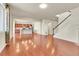 Open concept living space with hardwood floors and seamlessly connected living room, dining area, and kitchen at 3310 Quicksilver Rd, Frederick, CO 80516