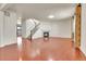 Spacious living area with hardwood floors, a fireplace, a staircase, and a view into the adjacent room at 3310 Quicksilver Rd, Frederick, CO 80516