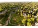 Gorgeous aerial view of neighborhood featuring mature trees, pond, trails, and luxury houses at 4935 E Preserve Ln, Greenwood Village, CO 80121