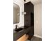Elegant bathroom features modern vanity with stone countertop and decorative lighting fixture at 4935 E Preserve Ln, Greenwood Village, CO 80121