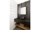 Modern powder room featuring hexagon tile wall, vessel sink, and sleek black faucet at 4935 E Preserve Ln, Greenwood Village, CO 80121
