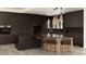 Modern kitchen with dark cabinets, unique island design, and contemporary pendant lighting at 4935 E Preserve Ln, Greenwood Village, CO 80121