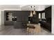Modern kitchen with sleek black cabinetry, a stylish island with seating, and chic pendant lighting at 4935 E Preserve Ln, Greenwood Village, CO 80121