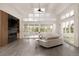 Bright living room with a fireplace, large windows, and glass doors leading to an outdoor deck at 4935 E Preserve Ln, Greenwood Village, CO 80121