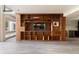 Spacious living room with custom wood built-ins, TV and shelving, plus large picture windows at 4935 E Preserve Ln, Greenwood Village, CO 80121