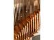 Close-up view of wood staircase with vertical slat details and natural light at 4935 E Preserve Ln, Greenwood Village, CO 80121