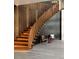 Modern staircase featuring wood treads, vertical slat details, and unique metal chairs at 4935 E Preserve Ln, Greenwood Village, CO 80121