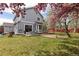 A well-maintained backyard featuring lush green grass, a patio area, and blooming trees at 12742 Vrain St, Broomfield, CO 80020