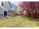 Lush backyard with blooming trees and a patio featuring an outdoor seating area, perfect for relaxing at 12742 Vrain St, Broomfield, CO 80020