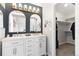 Bathroom featuring dual sinks, marble countertops, contemporary lighting, and a walk-in closet at 12742 Vrain St, Broomfield, CO 80020