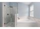 Elegant bathroom with glass-enclosed shower and luxurious soaking tub with marble-style details at 12742 Vrain St, Broomfield, CO 80020
