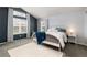 Stylish bedroom boasts large windows, a white metal bed frame, and a plush white rug at 12742 Vrain St, Broomfield, CO 80020