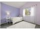 Light purple bedroom with plush rug, white furniture, and light from a window at 12742 Vrain St, Broomfield, CO 80020