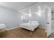 Cozy bedroom with a white metal bed frame, plush carpet, and a full bathroom through a door at 12742 Vrain St, Broomfield, CO 80020