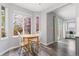 Bright breakfast nook with wood table and chairs near a window overlooking a garden at 12742 Vrain St, Broomfield, CO 80020
