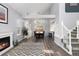 Dining room with fireplace, view of kitchen, wood floors, and abundant light at 12742 Vrain St, Broomfield, CO 80020