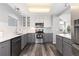 Modern kitchen features stainless appliances, granite counters, and gray cabinets with white subway tile at 12742 Vrain St, Broomfield, CO 80020