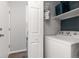 Laundry area includes a washing machine, shelving for storage, and access to hallway at 12742 Vrain St, Broomfield, CO 80020