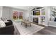 Light-filled living room with a fireplace, built-in shelves, and sliding glass door to yard at 12742 Vrain St, Broomfield, CO 80020