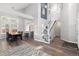 Open-concept living area with staircase, dining area, wood floors, and lots of natural light at 12742 Vrain St, Broomfield, CO 80020