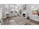 Light-filled living room with vaulted ceilings, fireplace, wood floors, and neutral decor at 12742 Vrain St, Broomfield, CO 80020