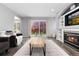 Open living room with fireplace, TV, backyard view, and contemporary decor at 12742 Vrain St, Broomfield, CO 80020