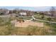 Aerial view of the neighborhood park, showing a playground with colorful slides and swings at 12742 Vrain St, Broomfield, CO 80020