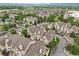 Expansive aerial view showcases a community with mature trees and winding streets at 9692 W Coco Cir # 304, Littleton, CO 80128
