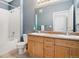 Bathroom with a double sink vanity, a bathtub with a shower, and a serene blue color scheme at 9692 W Coco Cir # 304, Littleton, CO 80128