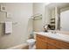 Well-lit bathroom with a modern vanity, a large mirror, and neutral décor creates a calming atmosphere at 9692 W Coco Cir # 304, Littleton, CO 80128