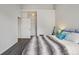 Inviting bedroom with a cozy bed, featuring neutral decor and a door to an attached space at 9692 W Coco Cir # 304, Littleton, CO 80128