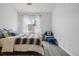 Bright bedroom with a comfortable bed, natural light, and a cozy seating area at 9692 W Coco Cir # 304, Littleton, CO 80128