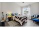 Well-lit bedroom showcasing a comfortable bed, decorative rug, and a large window at 9692 W Coco Cir # 304, Littleton, CO 80128