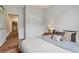 Comfortable bedroom featuring a large bed, soft lighting, and hardwood floors for a peaceful retreat at 9692 W Coco Cir # 304, Littleton, CO 80128