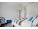 Bedroom featuring a cozy bed, seating area, and easy access to another room through a doorway at 9692 W Coco Cir # 304, Littleton, CO 80128