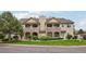 Inviting two-story townhome with stone accents, balconies, and well-manicured lawn at 9692 W Coco Cir # 304, Littleton, CO 80128
