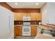 Modern kitchen featuring stainless steel appliances, light wood cabinets, and ample counter space at 9692 W Coco Cir # 304, Littleton, CO 80128