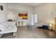Bright living room featuring hardwood floors, modern furnishings, and an open layout connected to the kitchen at 9692 W Coco Cir # 304, Littleton, CO 80128